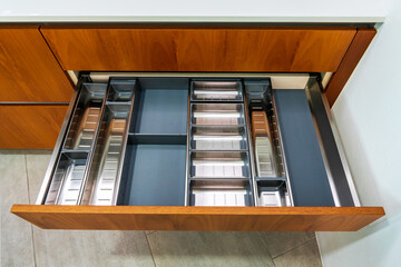 Modern Kitchen Drawer with Silver Utensil Tray and Wooden Cabinet for Organized Storage Solutions