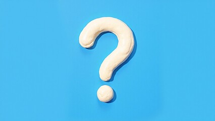 Naklejka premium Creative Clay Question Mark Shape on Bright Blue Background