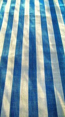 Fototapeta premium Blue and White Stripes: A vibrant textile pattern of bold blue and white stripes creates a modern and eye-catching surface.