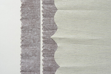 crepe paper sheets with zigzag and scalloped cut edges on blank paper