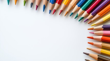 Sharpened tips of colorful pencils point inward, framing an empty canvas ready for ideas and inspiration.