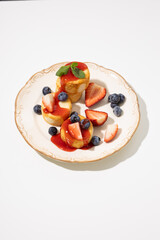 Close up of cottage cheese with berries on plate breakfast dish