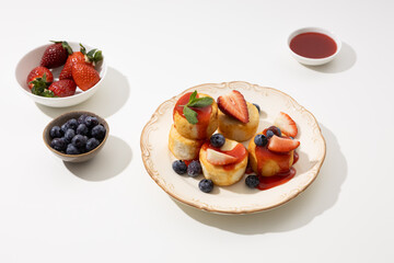 Cottage cheese with berries on plate breakfast dish light table