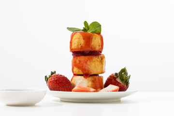 Stack of Syrniki fritters with strawberries syrup breakfast dish light table