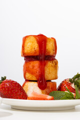 Close up of  cheese fritters with strawberries syrup pouring breakfast dish