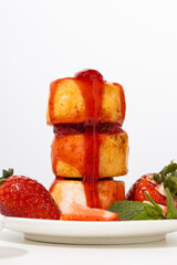 Close up of cheese pancakes with strawberries syrup pouring breakfast dish