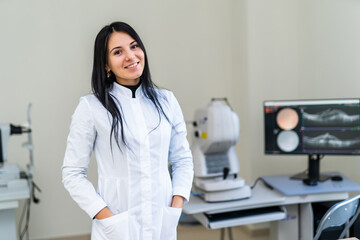 Smiling medical professional in a clinic. A confident medical professional in a white coat smiles...