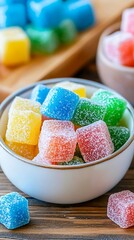 Colorful gummy candies in a bowl on wooden table