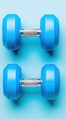 Obraz premium Blue dumbbells on blue background, fitness workout (1)