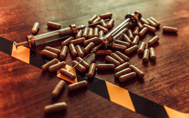 Social problems of drug addicts.Syringes and pills on the table in a dark treatment.