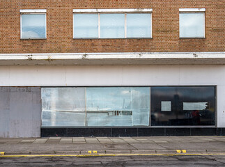 Closed and empty shops in a shopping centre depicting the dying UK high street.