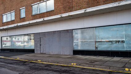 Closed and empty shops in a shopping centre depicting the dying UK high street.
