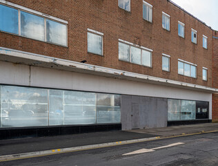 Closed and empty shops in a shopping centre depicting the dying UK high street.