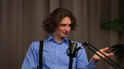 A young man recording a podcast or expert video in a professional studio.