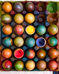 top view of a colored pallet with dyed Easter eggs with natural dyes