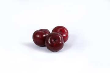read plum fruits in white background  