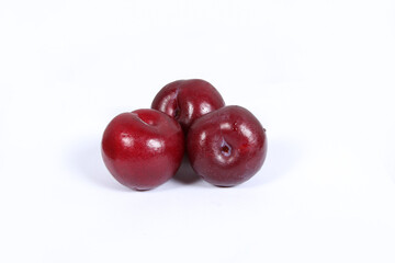read plum fruits in white background  