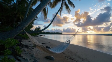 Obraz premium A hammock tied between two palm trees on a quiet beach, perfect for a peaceful vacation moment.