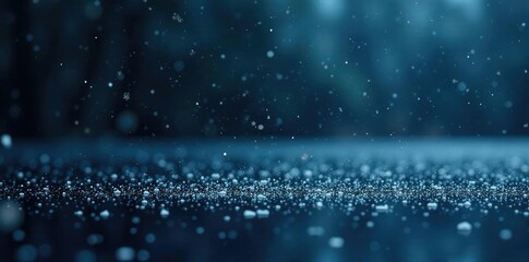 Obraz premium A flurry of snowflakes falls onto a black and icy lake surface, calm, winter, dark