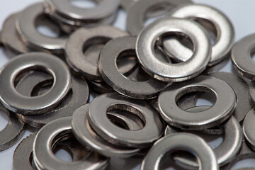 PIle of shiny screw washers.. Steel washers for screws used in carpentry and handicrafts for industrial.A lot of washers for fasteners. Heap of stainless shims. Background. PIle of shiny screw washers