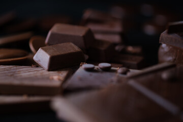 Close-up of various chocolate pieces in rich, dark tones, creating a luxurious and indulgent...