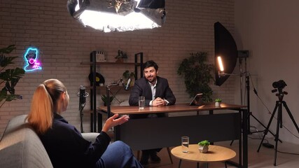 Engaging Interview in a Modern Studio Setting Featuring Two Speakers Discussing Various Topics