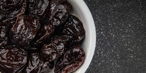 Dried prunes drained smoked plum delicious gourmet food background on the table rustic food top view copy space keto and paleo diet vegetarian and vegan food