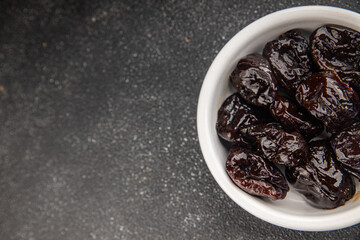 Dried prunes drained smoked plum delicious gourmet food background on the table rustic food top view copy space keto and paleo diet vegetarian and vegan food