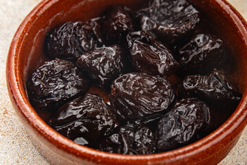 Dried prunes drained smoked plum delicious gourmet food background on the table rustic food top...