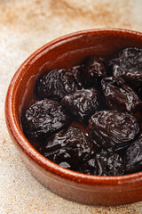 Dried prunes drained smoked plum delicious gourmet food background on the table rustic food top view copy space keto and paleo diet vegetarian and vegan food
