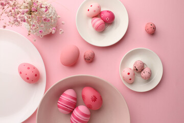 Easter holiday. Festive composition. Food decor. Homemade ornament. Creative colorful arrangement of painted pink blue yellow eggs with cute bunny chicken pattern isolated on light pastel background.