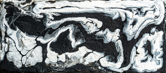 Beautiful black and white marble texture. Abstract background of flowing black and white paint with...