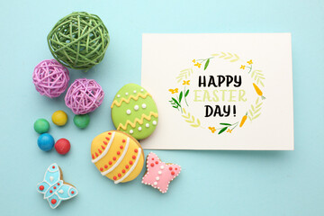 Easter composition. Easter eggs, flowers, paper blank on pastel background. Flat lay, top view, copy space.