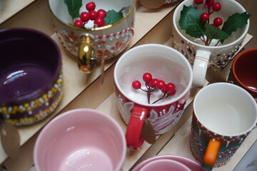 Mugs with different bright patterns. Craft fair.
