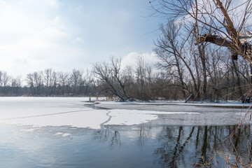Melting of cold water and ice in river in early spring. Meltwater and white tones of ice contrast...