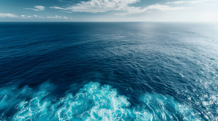 Tranquil Aerial View of the Expansive Ocean with Gentle Blue Waves and Sparkling Sunlight Creating an Atmosphere of Serenity and Endless Possibility