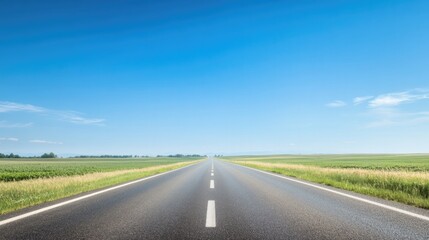 Fototapeta premium open road stretching under clear blue sky bordered by vast fields perfect for conveying freedom and exploration with