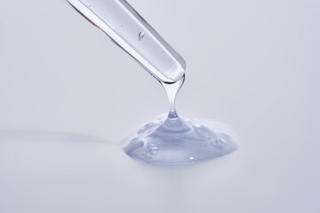 Pipette with delicate blue serum close-up.