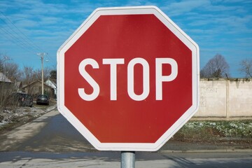 Red stop sign for traffic in rural area