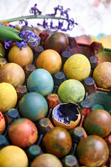 top view of a colored pallet with dyed Easter eggs with natural dyes