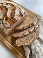 Photo of delicious homemade sourdough bread, freshly baked and sliced, revealing its soft, fluffy crumb and golden crust. The natural, organic home baked loaf. Healthy cooking and lifestyle.