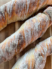 Close-up top view of a rustic sourdough root bread loaf with perfect crust. Homemade bread, freshly...