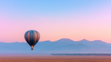 Fototapeta premium single hot air balloon drifts serenely at dawn its vibrant colors contrasting pastel morning sky over open plain mountains