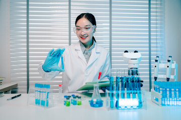 Woman in a lab coat is holding a blue object and smiling