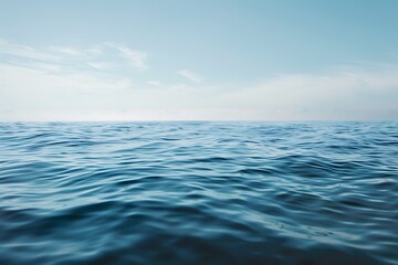 Obraz premium a calm ocean surface with water waves against clear blue sky