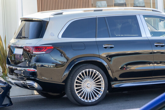 Black mercedes maybach gls 600 suv parked in urban setting