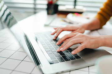 Typing on keyboard Working online on laptop computer On a white table at the office. Facebook chat. Web meeting. Blogger. Journalist writing an article. online job ideas
