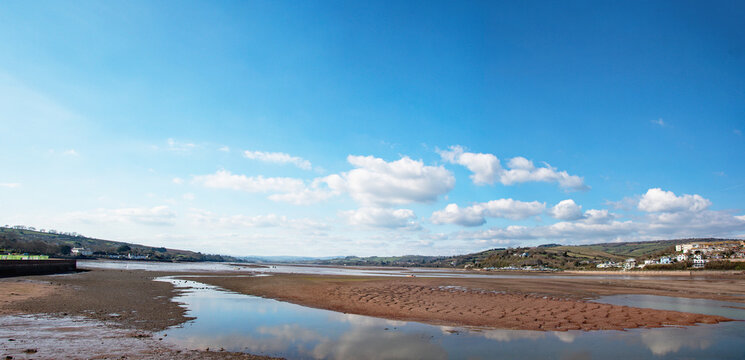 South west England coastal panoramic image with a scenic estuary with golden red sand. Vacation and holiday image.