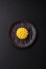 Round sweet tart of yellow color with citrus and passion fruit flavor