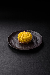 Round sweet tart of yellow color with citrus and passion fruit flavor